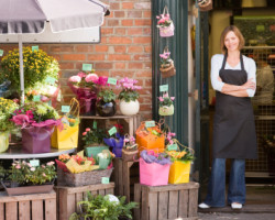 Woman working at flower shop smiling